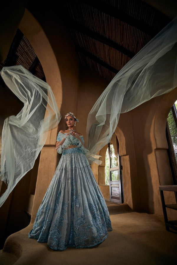 Powder blue silk tissue lehnga set with busiter blouse and overlap cape